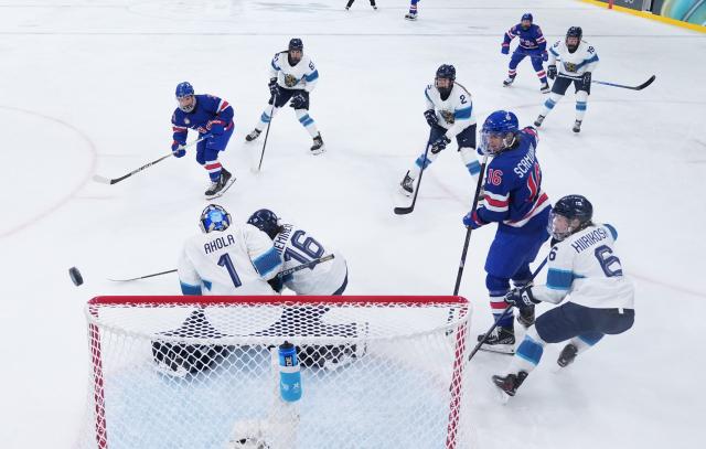 (260207) -- MILAN, Feb. 7, 2026 (Xinhua) -- Sanni Ahola (1st L, bottom) of Finland defends during the ice hockey women's preliminary round group A match between the United States and Finland at the Milan-Cortina 2026 Olympic Winter Games in Milan, Italy, Feb. 7, 2026. (Xinhua/Tao Xiyi)