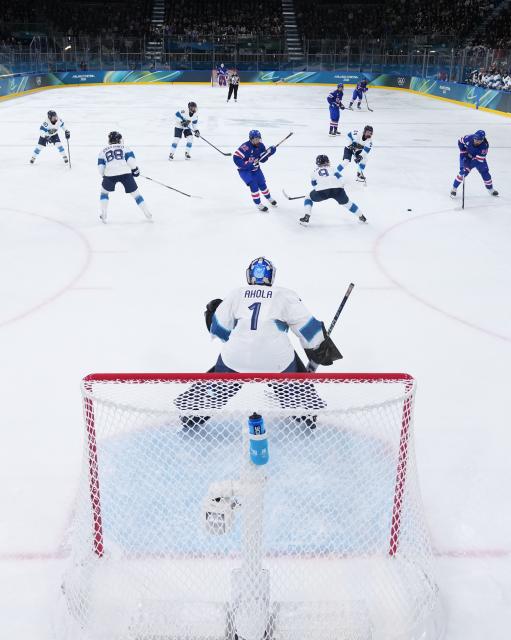 (260207) -- MILAN, Feb. 7, 2026 (Xinhua) -- Sanni Ahola (bottom) of Finland defends during the ice hockey women's preliminary round group A match between the United States and Finland at the Milan-Cortina 2026 Olympic Winter Games in Milan, Italy, Feb. 7, 2026. (Xinhua/Tao Xiyi)