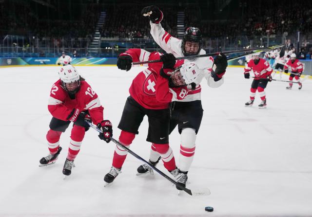 (260207) -- MILAN, Feb. 7, 2026 (Xinhua) -- Alessia Baechler (C) of Switzerland vies with Brianne Jenner (R) of Canada during the ice hockey women's preliminary round group A match between Switzerland and Canada at the Milan-Cortina 2026 Olympic Winter Games in Milan, Italy, Feb. 7, 2026. (Xinhua/Tao Xiyi)