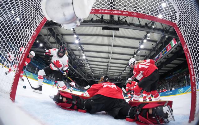 (260208) -- MILAN, Feb. 8, 2026 (Xinhua) -- Goalkeeper Saskia Maurer (C) of Switzerland defends during the ice hockey women's preliminary round group A match between Switzerland and Canada at the Milan-Cortina 2026 Olympic Winter Games in Milan, Italy, Feb. 7, 2026. (Tao Xiyi/Pool via Xinhua)