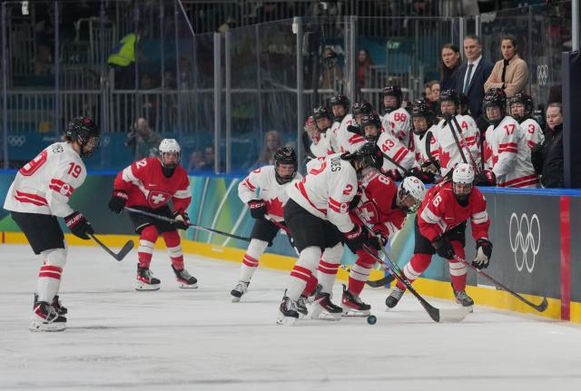 (260208) -- MILAN, Feb. 8, 2026 (Xinhua) -- Sophie Jaques (4th L) of Canada vies with Leoni Balzer (5th L) of Switzerland during the ice hockey women's preliminary round group A match between Switzerland and Canada at the Milan-Cortina 2026 Olympic Winter Games in Milan, Italy, Feb. 7, 2026. (Xinhua/Tao Xiyi)
