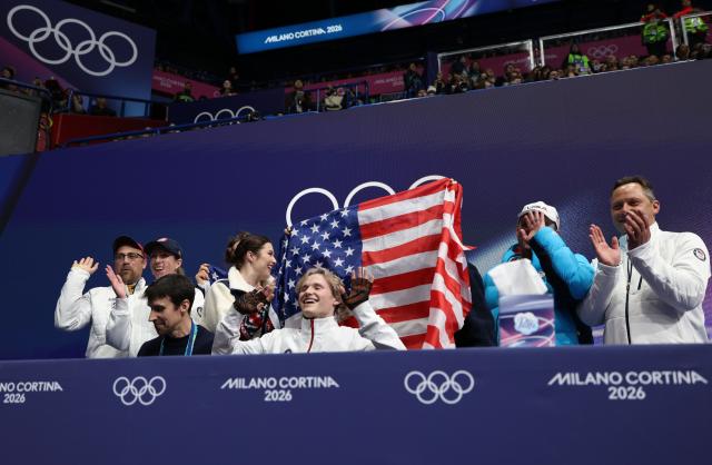 (260208) -- MILAN, Feb. 8, 2026 (Xinhua) -- Ilia Malinin (front R) of United States celebrates with his team after performing during the short program of men single skating for figure skating team event at the Milan-Cortina 2026 Olympic Winter Games in Milan, Italy, Feb. 7, 2026. (Xinhua/Chen Yichen)