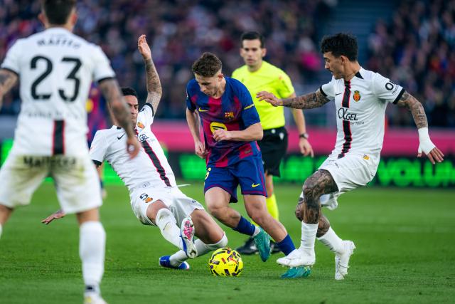 (260208) -- BARCELONA, Feb. 8, 2026 (Xinhua) -- Fermin Lopez (2nd R) of Barcelona vies with Omar Mascarell (2nd L) of Mallorca during La Liga football match between FC Barcelona and RCD Mallorca in Barcelona, Spain, Feb. 7, 2026. (Photo by Joan Gosa/Xinhua)