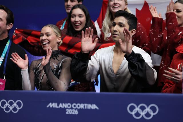 (260208) -- MILAN, Feb. 8, 2026 (Xinhua) -- Marjorie Lajoie (front L)/Zachary Lagha (front R) of Canada react to their scores after performing during the free dance of ice dance skating for figure skating team event at the Milan-Cortina 2026 Olympic Winter Games in Milan, Italy, Feb. 7, 2026. (Xinhua/Chen Yichen)