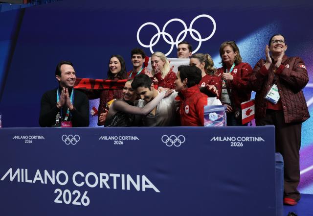 (260208) -- MILAN, Feb. 8, 2026 (Xinhua) -- Marjorie Lajoie (front 2nd L)/Zachary Lagha (front 2nd R) of Canada react to their scores after performing during the free dance of ice dance skating for figure skating team event at the Milan-Cortina 2026 Olympic Winter Games in Milan, Italy, Feb. 7, 2026. (Xinhua/Chen Yichen)
