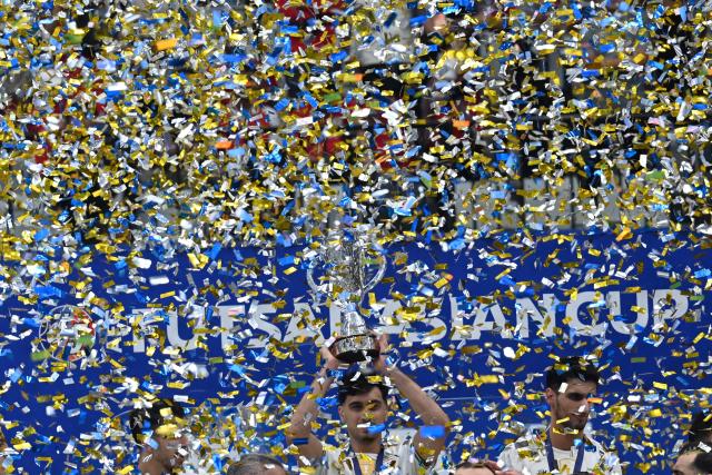 (260208) -- JAKARTA, Feb. 8, 2026 (Xinhua) -- Player of team Iran holds trophy during the awarding ceremony after the final match between Indonesia and Iran at the AFC Futsal Asian Cup 2026 in the Indonesia Arena stadium, Jakarta, Indonesia, Feb. 7, 2026. (Xinhua/Agung Kuncahya B.)