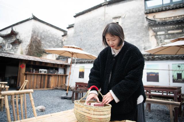 (260208) -- YIXIAN, Feb. 8, 2026 (Xinhua) -- A shop owner packs Spring Festival specialties in Bishan Village of Yixian County, east China's Anhui Province, Feb. 7, 2026.
  Ancient villages in Yixian County are filled with festive vibe as the Spring Festival approaches. Locals follow folk customs by making steamed rice cakes, fish lanterns, and writing spring couplets, drawing tourists to share the festive joy together. (Xinhua/Zhang Duan)