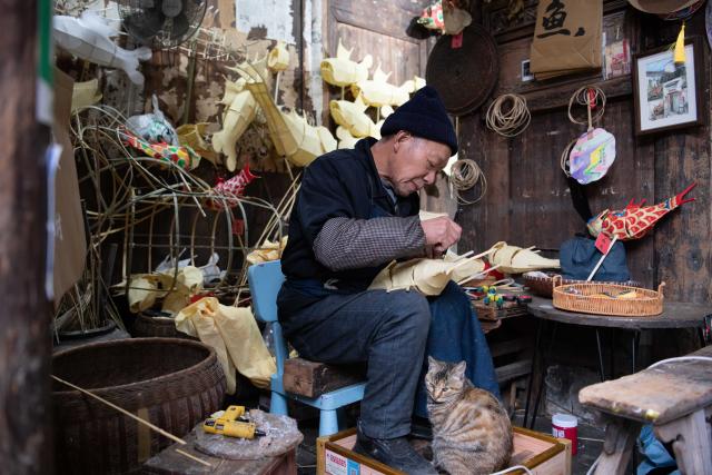 (260208) -- YIXIAN, Feb. 8, 2026 (Xinhua) -- A craftsman makes a fish lantern in Bishan Village of Yixian County, east China's Anhui Province, Feb. 7, 2026.
  Ancient villages in Yixian County are filled with festive vibe as the Spring Festival approaches. Locals follow folk customs by making steamed rice cakes, fish lanterns, and writing spring couplets, drawing tourists to share the festive joy together. (Xinhua/Zhang Duan)