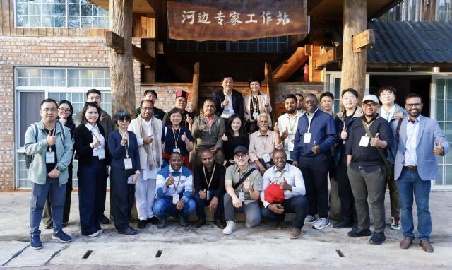 (260208) -- KUNMING, Feb. 8, 2026 (Xinhua) -- People from Global South countries pose for group photos at Hebian Village in Mengla County, southwest China's Yunnan Province, Dec. 5, 2025. TO GO WITH "China Focus: Global South youth explore rural development models in SW China's Yunnan" (Xinhua)