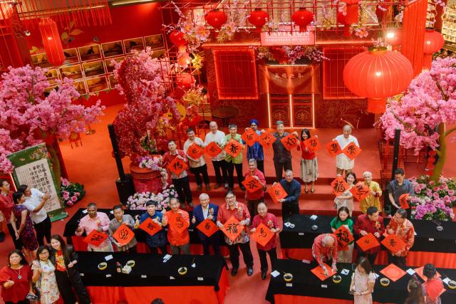 (260208) -- KUALA LUMPUR, Feb. 8, 2026 (Xinhua) -- People participate in a calligraphy event in celebration of the upcoming Spring Festival in Kuala Lumpur, Malaysia, Feb. 8, 2026. (Photo by Chong Voon Chung/Xinhua)