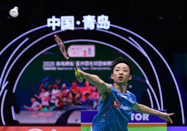 (260208) -- QINGDAO, Feb. 8, 2026 (Xinhua) -- Tanaka Yushi of Japan hits a return against Hu Zhean of China during the men's team final match between China and Japan at Badminton Asia Team Championships 2026 in Qingdao, east China's Shandong Province, Feb. 8, 2026. (Xinhua/Li Ziheng)