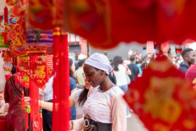 (260208) -- NAIROBI, Feb. 8, 2026 (Xinhua) -- People look at Chinese New Year decorations at the 2026 Chinese New Year Gala in Nairobi, Kenya, Feb. 8, 2026. Kenya on Sunday celebrated the 2026 Chinese New Year Gala in Nairobi, bringing together dignitaries including senior government officials, diplomats, industry leaders, and hundreds of local and foreign visitors.
   The day-long event, held at Two Rivers Mall, featured cultural performances such as dragon and lion dances, contemporary music, and showcases of Chinese costumes and cuisine. (Xinhua/Xie Jianfei)
