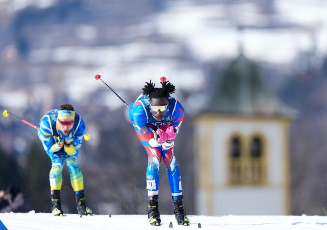 (260208) -- TESERO, Feb. 8, 2026 (Xinhua) -- Stevenson Savart of Haiti (front) competes during the cross-country skiing men's 10km+10km skiathlon at the Milan-Cortina 2026 Olympic Winter Games in Tesero, Italy, Feb. 8, 2026. (Xinhua/He Canling)