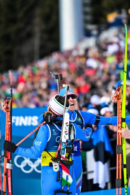 (260208) -- ANTERSELVA, Feb. 8, 2026 (Xinhua) -- Dorothea Wierer (L) and Lisa Vittozzi of Italy celebrate after the biathlon mixed relay 4 x 6km (M+W) at the Milan-Cortina 2026 Olympic Winter Games in Anterselva, Italy, Feb. 8, 2026. (Xinhua/Jiang Han)