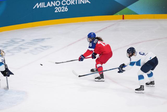 (260208) -- MILAN, Feb. 8, 2026 (Xinhua) -- Natalie Mlynkova (L) of the Czech Republic shoots during the ice hockey women's preliminary round group A match between the Czech Republic and Finland at the Milan-Cortina 2026 Olympic Winter Games in Milan, Italy, Feb. 8, 2026. (Xinhua/Tao Xiyi)
