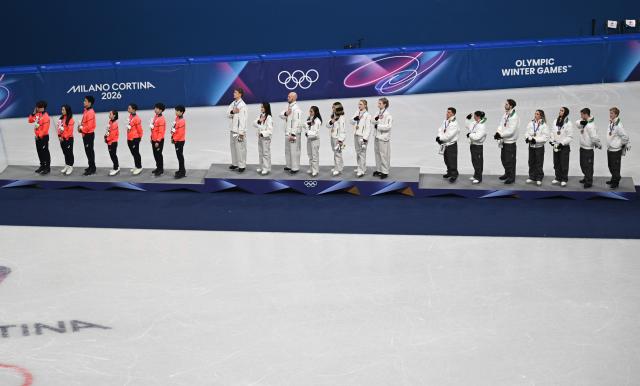 (260209) -- MILAN, Feb. 9, 2026 (Xinhua) -- Gold medalists team the United States (C), silver medalists team Japan (L) and bronze medalists team Italy react during the awarding ceremony for the figure skating team event of the Milan-Cortina 2026 Olympic Winter Games in Milan, Italy, Feb. 8, 2026. (Xinhua/Cheng Min)