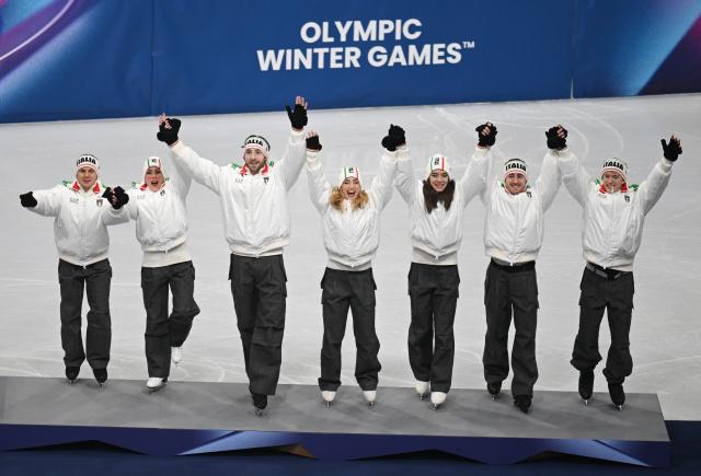(260209) -- MILAN, Feb. 9, 2026 (Xinhua) -- Bronze medalists team Italy step on the podium during the awarding ceremony for the figure skating team event of the Milan-Cortina 2026 Olympic Winter Games in Milan, Italy, Feb. 8, 2026. (Xinhua/Cheng Min)