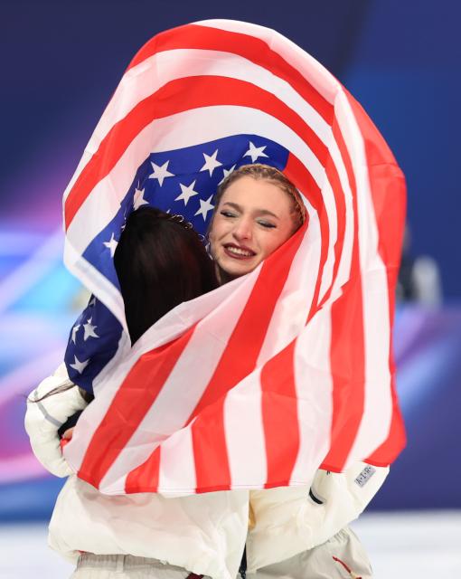 (260209) -- MILAN, Feb. 9, 2026 (Xinhua) -- Amber Glenn (R) of team the United States celebrates with her teammate after the awarding ceremony for the figure skating team event of the Milan-Cortina 2026 Olympic Winter Games in Milan, Italy, Feb. 8, 2026. (Xinhua/Li Ming)