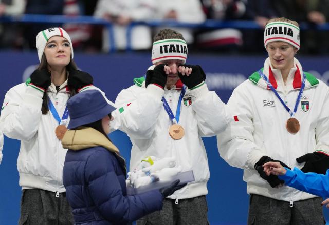 (260209) -- MILAN, Feb. 9, 2026 (Xinhua) -- Bronze medalist Matteo Rizzo (C) of team Italy reacts during the awarding ceremony for the figure skating team event of the Milan-Cortina 2026 Olympic Winter Games in Milan, Italy, Feb. 8, 2026. (Xinhua/Xue Yuge)