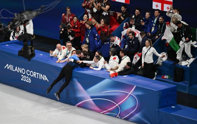 (260209) -- MILAN, Feb. 9, 2026 (Xinhua) -- Matteo Rizzo of Italy (L, bottom) celebrates with his team after performing during the figure skating team event men single skating free skating of the Milan-Cortina 2026 Olympic Winter Games in Milan, Italy, Feb. 8, 2026. (Xinhua/Cheng Min)