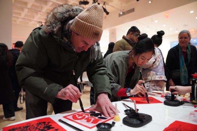 (260209) -- NEW YORK, Feb. 9, 2026 (Xinhua) -- People experience Chinese calligraphy during the Taste of China cultural event in New York, the United States, on Feb. 8, 2026. A cultural event titled the Taste of China was held here on Sunday to celebrate the Chinese New Year. (Xinhua/Zhang Fengguo)