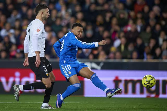 (260209) -- VALENCIA, Feb. 9, 2026 (Xinhua) -- Kylian Mbappe (R) of Real Madrid shoots the ball during the La Liga football match between Valencia CF and Real Madrid in Valencia, Spain, Feb. 8, 2026. (Str/Xinhua)