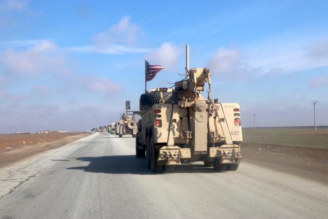 (260209) -- BEIJING, Feb. 9, 2026 (Xinhua) -- U.S. military vehicles escort passenger buses transporting Islamic State (IS) detainees from northeastern Syria into Iraq on Feb. 8, 2026. Iraq has received 2,250 IS terrorist detainees from Syria and commenced legal classification procedures against them, the Iraqi military said on Feb. 7.
   The transfer was conducted in coordination with the International Coalition tasked with fighting IS and through great efforts by the security forces, said Lieutenant General Saad Maan, head of the Security Media Cell, a media outlet affiliated with the Iraqi Joint Operations Command. (Str/Xinhua)