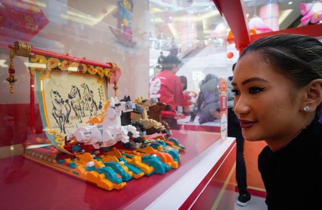 (260209) -- BURNABY, Feb. 9, 2026 (Xinhua) -- A woman takes a closer look at a Year of the Horse-themed LEGO model during a LEGO pop-up event to celebrate the upcoming Year of the Horse at Metrotown Shopping Mall in Burnaby, British Columbia, Canada, on Feb. 8, 2026. (Photo by Liang Sen/Xinhua)