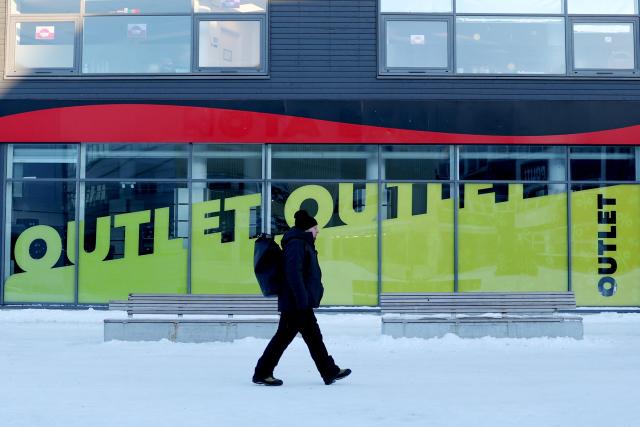 (260209) -- NUUK, Feb. 9, 2026 (Xinhua) -- A man walks past an Outlets in Nuuk, Greenland, an autonomous territory of Denmark, on Feb. 8, 2026. (Xinhua/Li Ying)