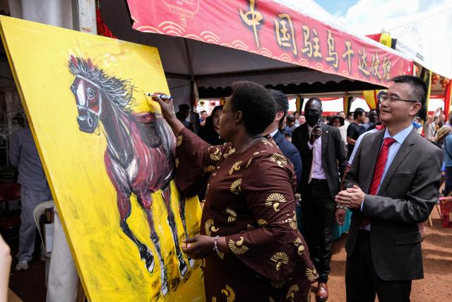 (260209) -- KAMPALA, Feb. 9, 2026 (Xinhua) -- Ugandan Vice President Jessica Alupo signs on a painting depicting a horse during a temple fair to launch the China-Uganda Year of People-to-People Exchange and celebrate the upcoming Chinese New Year in Kampala, Uganda, Feb. 8, 2026. Uganda launched the China-Uganda Year of People-to-People Exchange on Sunday in the capital, Kampala, during a temple fair held to celebrate the upcoming Chinese New Year, also known as the Spring Festival. (Photo by Hajarah Nalwadda/Xinhua)