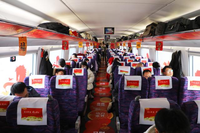 (260209) -- LANZHOU, Feb. 9, 2026 (Xinhua) -- Passengers take the train G848 in northwest China's Gansu Province, Feb. 9, 2026. As part of the mobile museum on the high-speed railway program, the train G848, carrying cultural relics interpreters, departed from Lanzhou West Railway Station heading to Guangzhou South Railway Station on Monday.
   Nine of China's national first-grade museums in Gansu, including the Dunhuang Academy and Gansu Provincial Museum, have brought the cultural heritage of Gansu onto the train, allowing passengers to touch history and get to know traditional custom during the Spring Festival travel rush. (Xinhua/Zhang Zhimin)