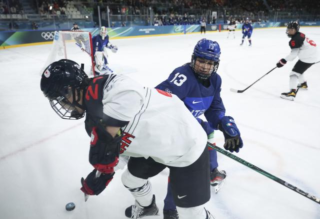(260209) -- MILAN, Feb. 9, 2026 (Xinhua) -- Laura Lobis of Italy (R, front) vies with Miura Mei of Japan (L, front) during the ice hockey women's preliminary round group B match between Japan and Italy at the Milan-Cortina 2026 Olympic Winter Games in Milan, Italy, Feb. 9, 2026. (Xinhua/Zhang Cheng)