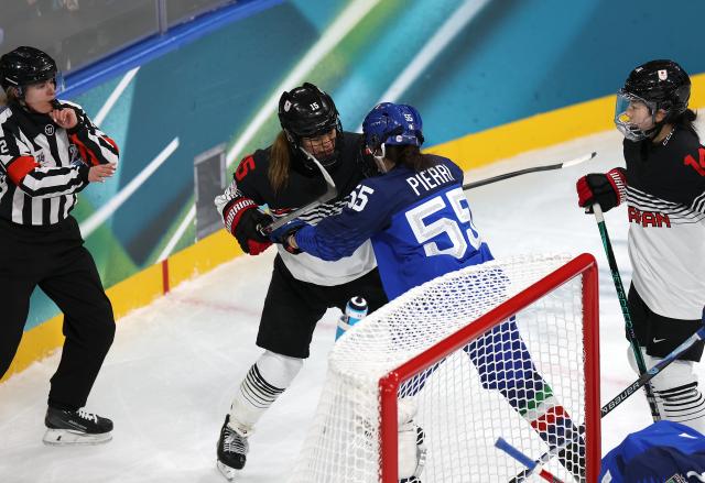 (260209) -- MILAN, Feb. 9, 2026 (Xinhua) -- Jacquie Pierri of Italy (2nd R) quarrels with Ukita Rui of Japan (2nd L) during the ice hockey women's preliminary round group B match between Japan and Italy at the Milan-Cortina 2026 Olympic Winter Games in Milan, Italy, Feb. 9, 2026. (Xinhua/Meng Chenguang)