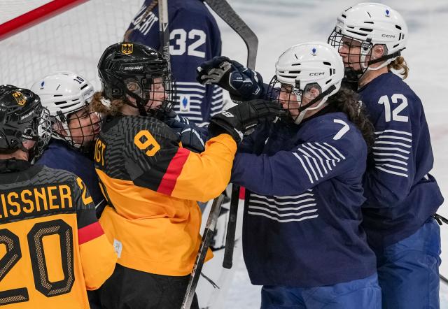 (260209) -- MILAN, Feb. 9, 2026 (Xinhua) -- Svenja Voigt (3rd L) of Germany conflicts with Lucie Quarto (2nd R) of France during the ice hockey women's preliminary round group B match between Germany and France at the Milan-Cortina 2026 Olympic Winter Games in Milan, Italy, Feb. 9, 2026. (Xinhua/Sun Fei)