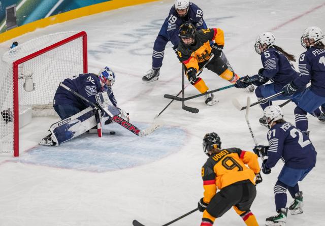 (260209) -- MILAN, Feb. 9, 2026 (Xinhua) -- Luisa Welcke (3rd L) of Germany shoots during the ice hockey women's preliminary round group B match between Germany and France at the Milan-Cortina 2026 Olympic Winter Games in Milan, Italy, Feb. 9, 2026. (Xinhua/Sun Fei)
