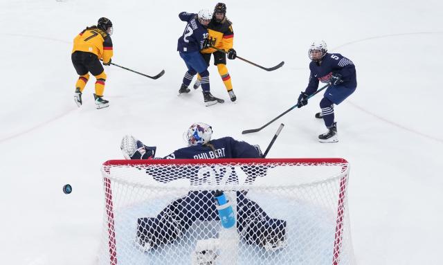 (260209) -- MILAN, Feb. 9, 2026 (Xinhua) -- Goalkeeper Alice Philbert (bottom) of France defends during the ice hockey women's preliminary round group B match between Germany and France at the Milan-Cortina 2026 Olympic Winter Games in Milan, Italy, Feb. 9, 2026. (Xinhua/Wang Kaiyan)