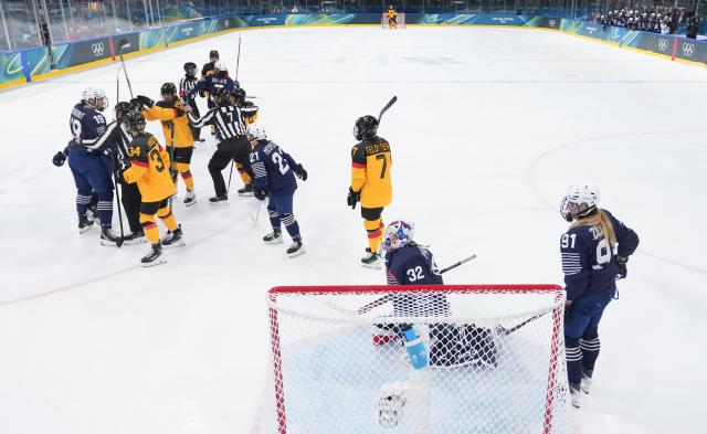 (260209) -- MILAN, Feb. 9, 2026 (Xinhua) -- Players of both sides conflict during the ice hockey women's preliminary round group B match between Germany and France at the Milan-Cortina 2026 Olympic Winter Games in Milan, Italy, Feb. 9, 2026. (Xinhua/Wang Kaiyan)