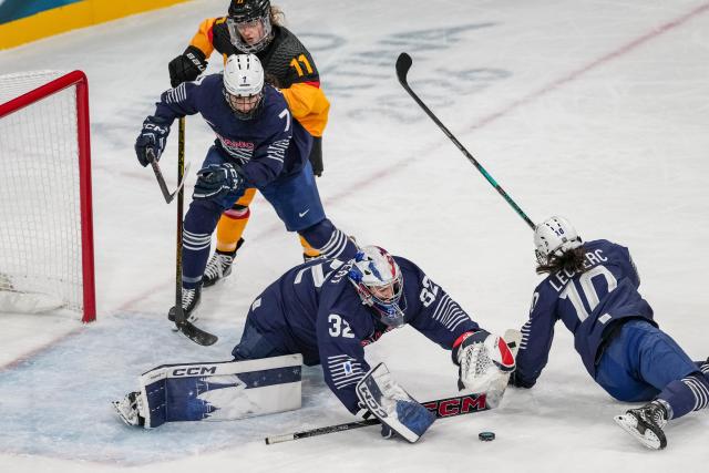 (260209) -- MILAN, Feb. 9, 2026 (Xinhua) -- Goalkeeper Alice Philbert (2nd R) of France saves a goal during the ice hockey women's preliminary round group B match between Germany and France at the Milan-Cortina 2026 Olympic Winter Games in Milan, Italy, Feb. 9, 2026. (Xinhua/Sun Fei)