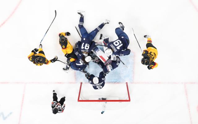 (260209) -- MILAN, Feb. 9, 2026 (Xinhua) -- Players of both sides vie for the puck during the ice hockey women's preliminary round group B match between Germany and France at the Milan-Cortina 2026 Olympic Winter Games in Milan, Italy, Feb. 9, 2026. (Xinhua/Wang Kaiyan)