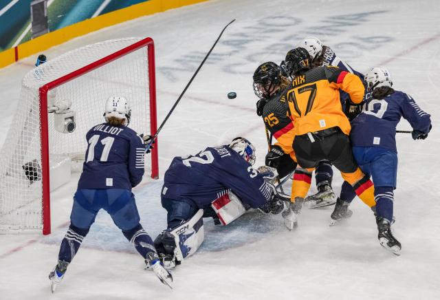 (260209) -- MILAN, Feb. 9, 2026 (Xinhua) -- Goalkeeper Alice Philbert (2nd L) of France tries to save a goal during the ice hockey women's preliminary round group B match between Germany and France at the Milan-Cortina 2026 Olympic Winter Games in Milan, Italy, Feb. 9, 2026. (Xinhua/Sun Fei)