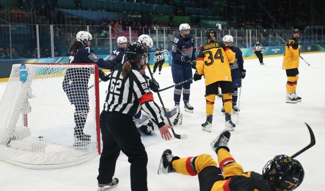 (260209) -- MILAN, Feb. 9, 2026 (Xinhua) -- Players of both sides conflict during the ice hockey women's preliminary round group B match between Germany and France at the Milan-Cortina 2026 Olympic Winter Games in Milan, Italy, Feb. 9, 2026. (Xinhua/Wang Kaiyan)