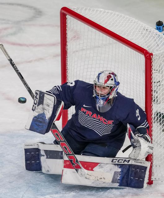 (260209) -- MILAN, Feb. 9, 2026 (Xinhua) -- Goalkeeper Alice Philbert of France saves a goal during the ice hockey women's preliminary round group B match between Germany and France at the Milan-Cortina 2026 Olympic Winter Games in Milan, Italy, Feb. 9, 2026. (Xinhua/Sun Fei)