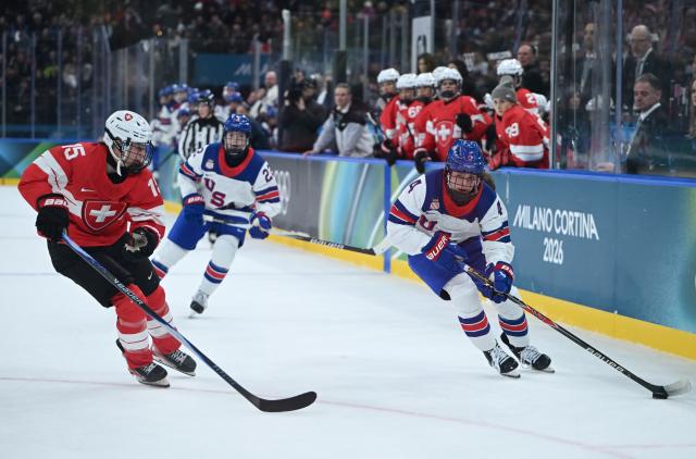 (260209) -- MILAN, Feb. 9, 2026 (Xinhua) -- Laure Meriguet (L) of Switzerland vies with Caroline Harvey (R) of the United States during the ice hockey women's preliminary round group A match between Switzerland and the United States at the Milan-Cortina 2026 Olympic Winter Games in Milan, Italy, Feb. 9, 2026. (Xinhua/Zhang Haofu)