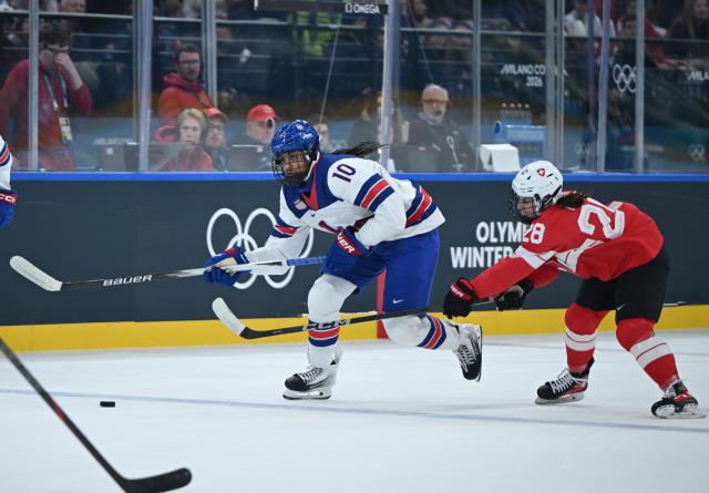 (260209) -- MILAN, Feb. 9, 2026 (Xinhua) -- Alina Marti (R) of Switzerland vies with Laila Edwards of the United States during the ice hockey women's preliminary round group A match between Switzerland and the United States at the Milan-Cortina 2026 Olympic Winter Games in Milan, Italy, Feb. 9, 2026. (Xinhua/Zhang Haofu)
