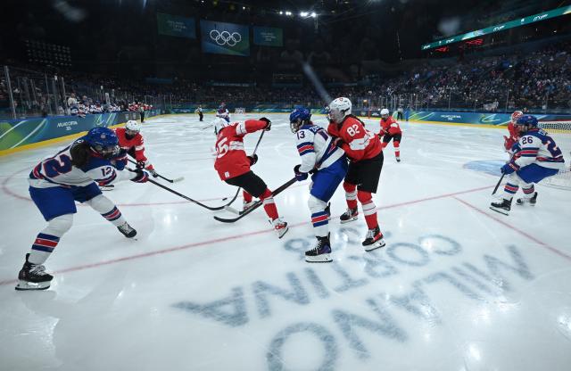 (260210) -- MILAN, Feb. 10, 2026 (Xinhua) -- Players of both sides vie for the puck during the ice hockey women's preliminary round group A match between Switzerland and the United States at the Milan-Cortina 2026 Olympic Winter Games in Milan, Italy, Feb. 9, 2026. (Xinhua/Zhang Haofu)