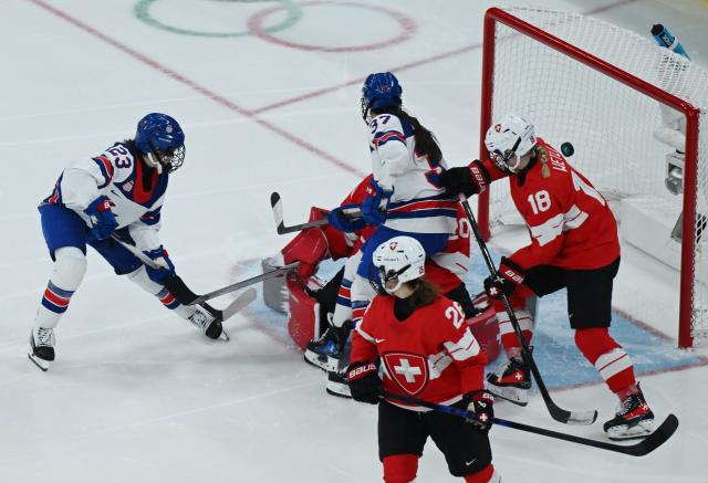 (260210) -- MILAN, Feb. 10, 2026 (Xinhua) -- Players of both sides vie for the puck during the ice hockey women's preliminary round group A match between Switzerland and the United States at the Milan-Cortina 2026 Olympic Winter Games in Milan, Italy, Feb. 9, 2026. (Xinhua/Zhang Haofu)