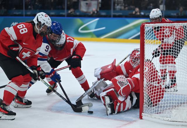 (260210) -- MILAN, Feb. 10, 2026 (Xinhua) -- Players of both sides vie for the puck during the ice hockey women's preliminary round group A match between Switzerland and the United States at the Milan-Cortina 2026 Olympic Winter Games in Milan, Italy, Feb. 9, 2026. (Xinhua/Zhang Haofu)
