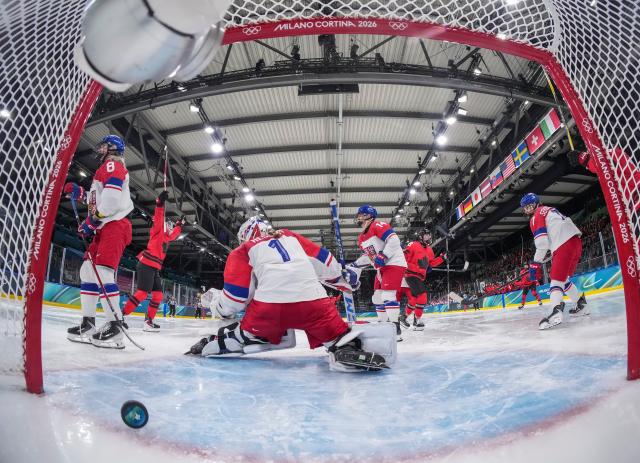 (260210) -- MILAN, Feb. 10, 2026 (Xinhua) -- Goalkeeper Michaela Hesova(3rd L) of the Czech Republic fails to save a goal during the ice hockey women's preliminary round group A match between Canada and the Czech Republic at the Milan-Cortina 2026 Olympic Winter Games in Milan, Italy, Feb. 9, 2026. (Sun Fei/Pool via Xinhua)