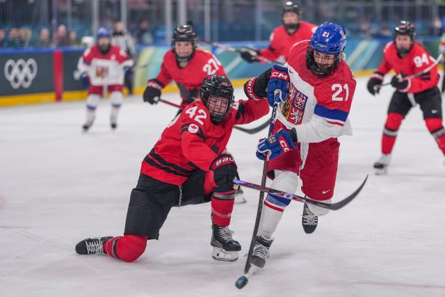 (260210) -- MILAN, Feb. 10, 2026 (Xinhua) -- Tereza Vanisova(front R) of the Czech Republic breaks through during the ice hockey women's preliminary round group A match between Canada and the Czech Republic at the Milan-Cortina 2026 Olympic Winter Games in Milan, Italy, Feb. 9, 2026. (Xinhua/Sun Fei)