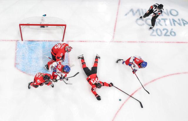 (260210) -- MILAN, Feb. 10, 2026 (Xinhua) -- Erin Ambrose(2nd R) of Canada vies with Adela Sapovalivova(1st R) of the Czech Republic during the ice hockey women's preliminary round group A match between Canada and the Czech Republic at the Milan-Cortina 2026 Olympic Winter Games in Milan, Italy, Feb. 9, 2026. (Xinhua/Sun Fei)